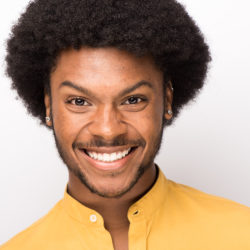 Jakevis Thomason smiling wearing a yellow shirt