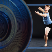 Video Stage camera and dancer wearing a blue shirt and black shorts reaching his arm out