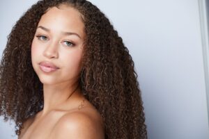 close up of a girl with brown curly hair