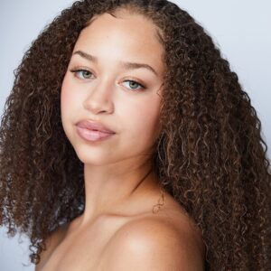 close up of a girl with brown curly hair