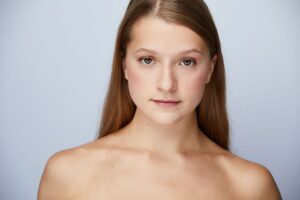 close up of a girl with straight blonde hair