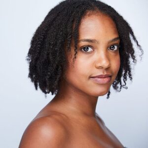 close up of a girl with short curly hair