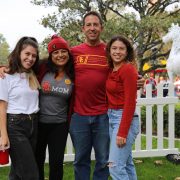 Two young women with parents in USC clothing