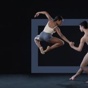 one dancer jumping and the other holding her hand