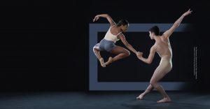 one dancer jumping and the other holding her hand