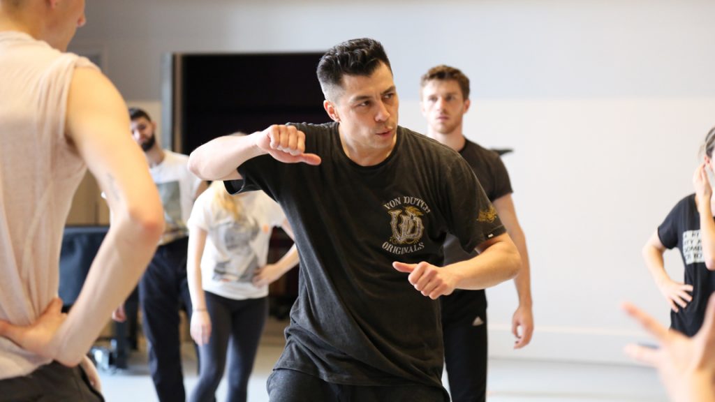 Man moving arms in front of class