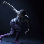 female dancer looking to her right with her right arm up