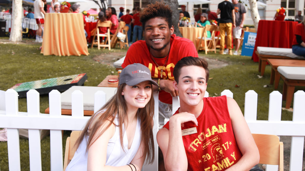 3 students in USC apparel smile