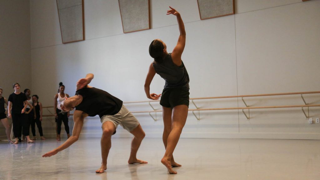 two dancers rehearsing in a studio