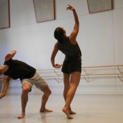 two dancers rehearsing in a studio