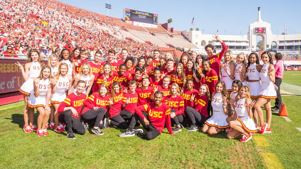 Students in red USC shirts on football field
