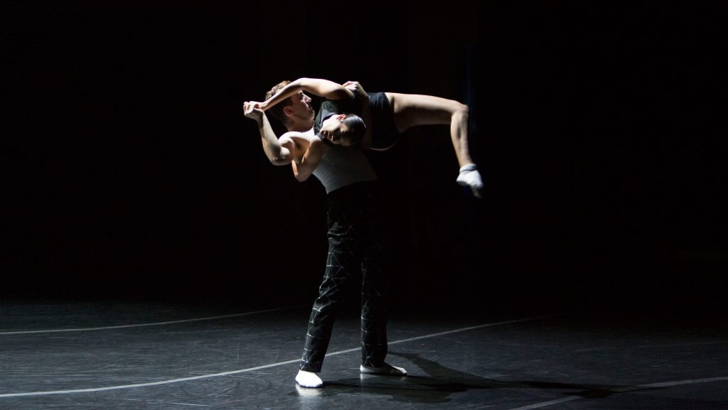 Man lifting woman over his shoulder