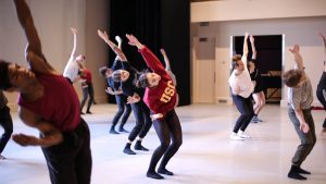 Class of students with girl in the middle wearing USC sweatshirt