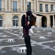 man lifting woman in palace