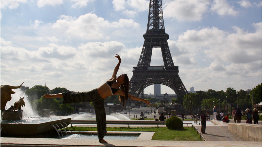 Woman dancing in front of eiffel tower