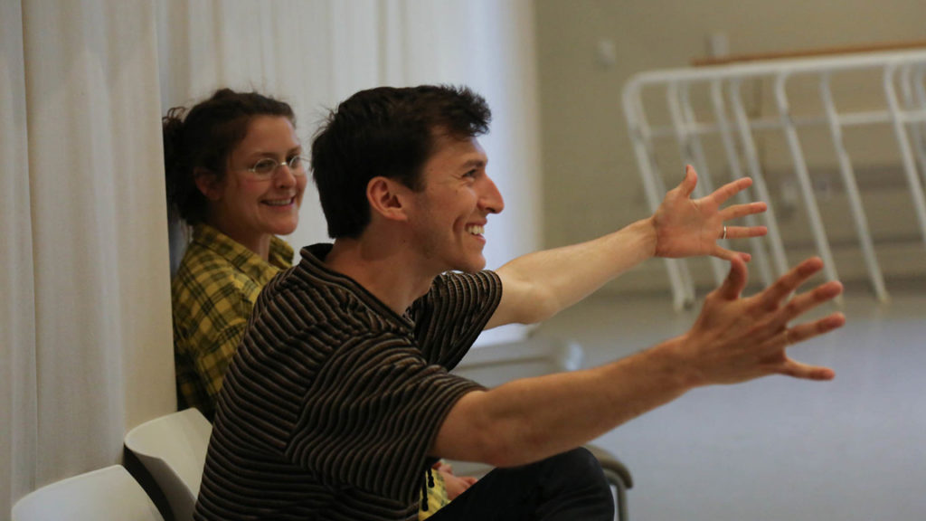 Man teaching dance in striped shirt