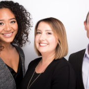 Leanna, Anne and Elliott pose in front of a white background
