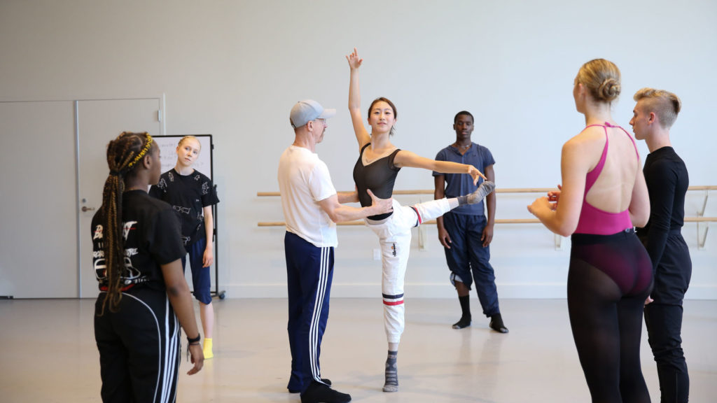 William Forsythe partners Eileen Kim as she balances with one leg extended behind them