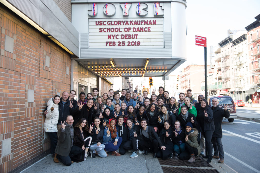 A group poses outside of a theater with a marquee that reads "JOYCE: USC Glorya Kaufman School of Dance NYC Debut, Feb 28 2019"