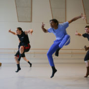 Four dancers rehearse in a studio