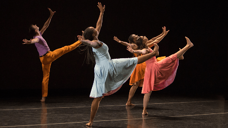 dancers with right legs and both arms in air