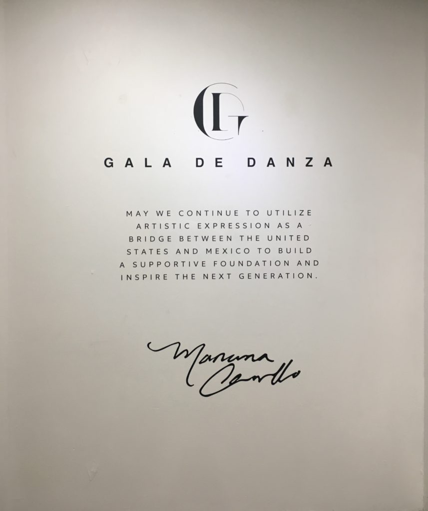 A white wall shows Mariana's mission statement and autograph