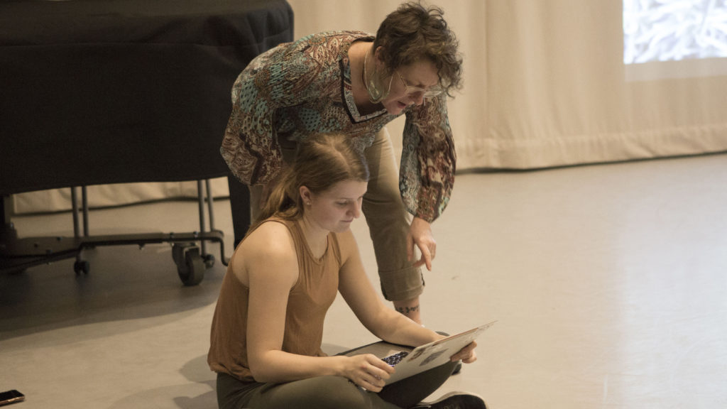 India Dobbie working on a laptop with Professor Dawn Stoppiello