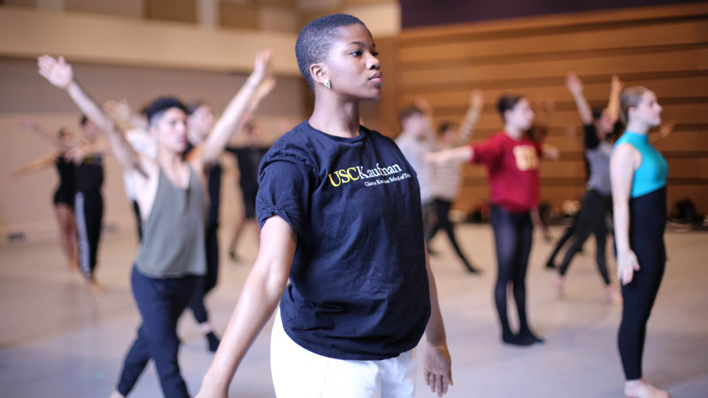 girl standing in a dance class wearing a black shirt