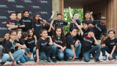 32nd Street Elementary School students pose wearing black Dance On t-shirts