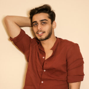 Headshot of Jainil Mehta wearing a rust colored button down shirt