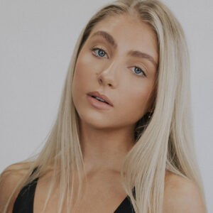 Jessalyn Ward looking straight at camera with head tilted left