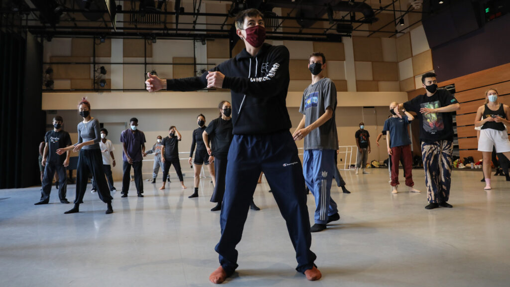 Peter Chu wearing maroon mask, black sweatshirt, and navy sweatpants