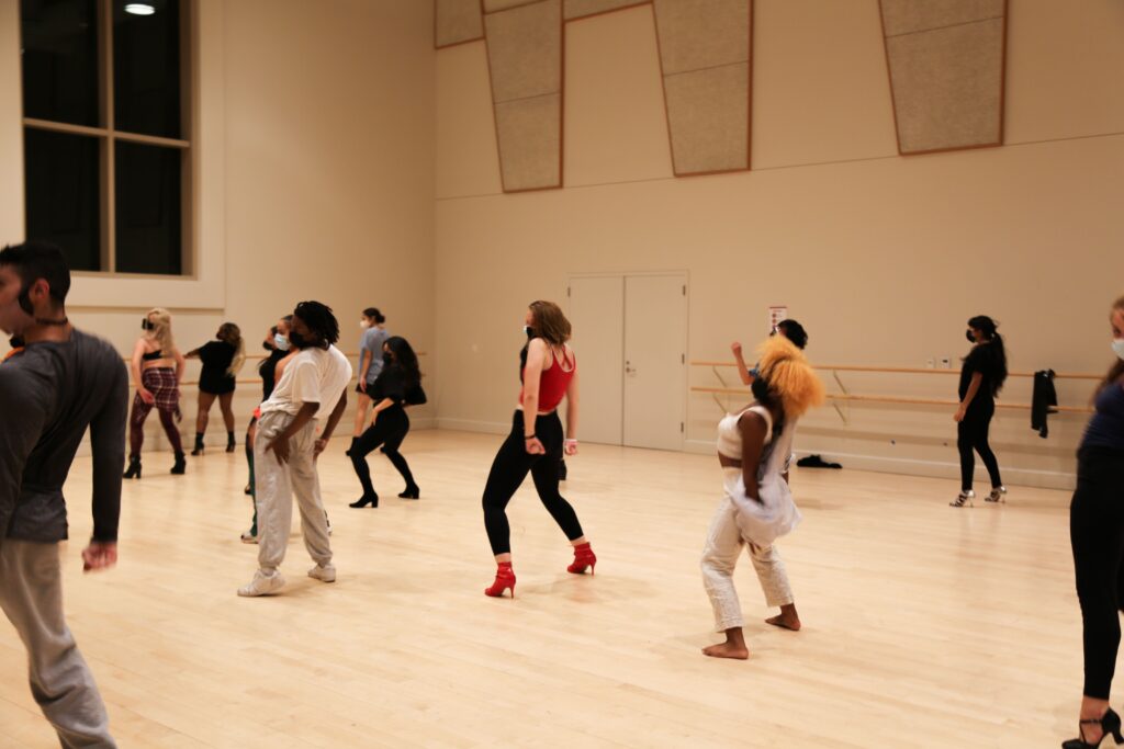 group of dancers in heels in a large studio