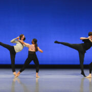 two sets of dancers on stage in arabesque