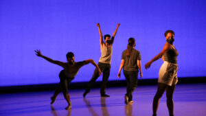 four dancers perform onstage