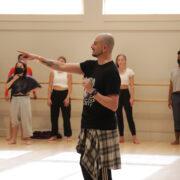 Brian Friedman pointing with his right arm outstretched