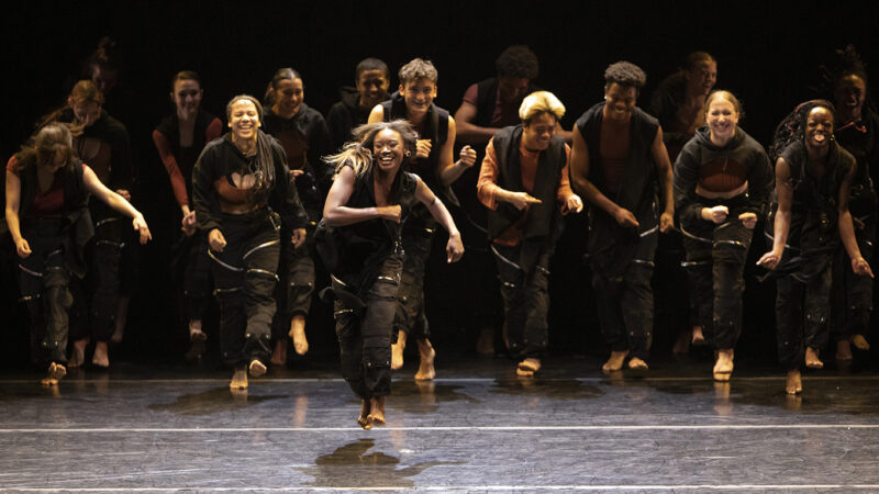 Dancers wearing black and smiling