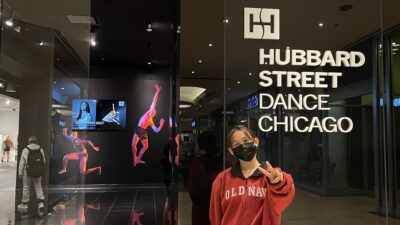 Summer Vu stands in front of a Hubbard Street Dance Chicago sign