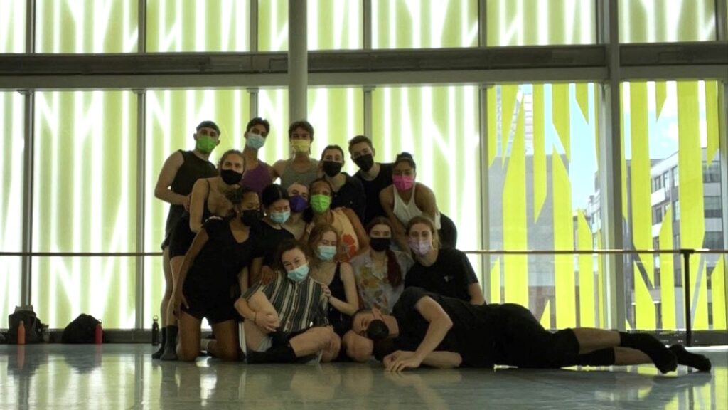 Anthony Tette and other dancers pose for a photo after rehearsal