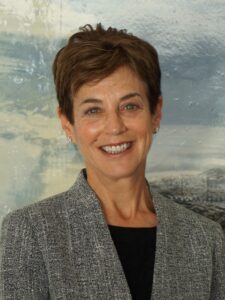 Joan E. Herman smiling wearing gray suit jacket and black blouse