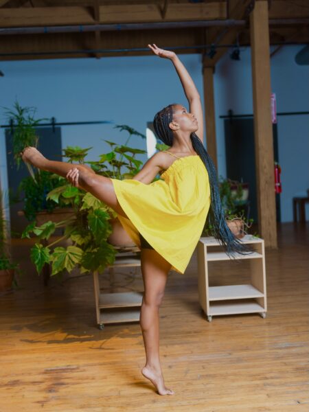 dancer wearing yellow dress in attitude