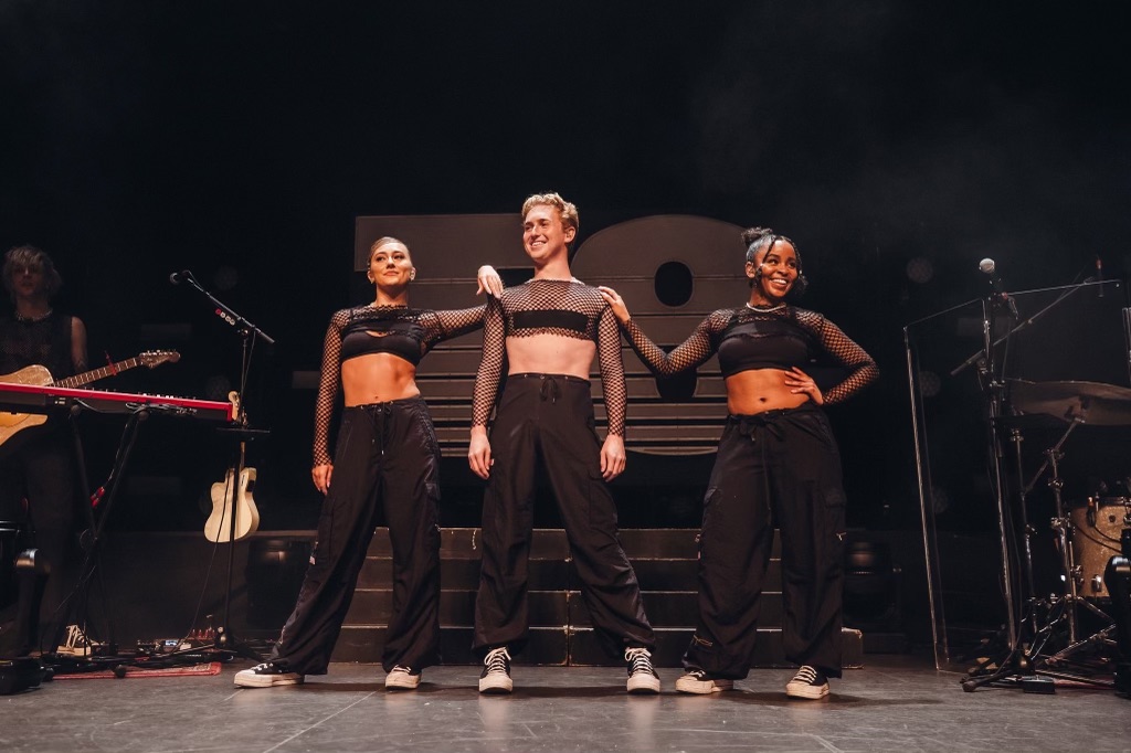Findlay McConnell (BFA '23) with dancers onstage for Tate McRae's tour