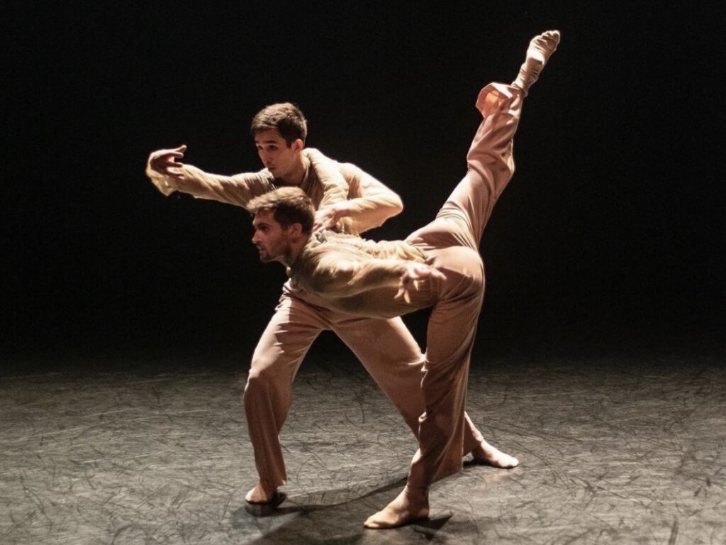 two men dancing on stage