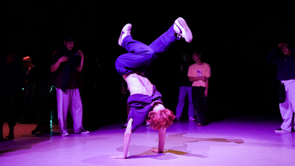 Marcel Cavaliere in a handstand during a cypher