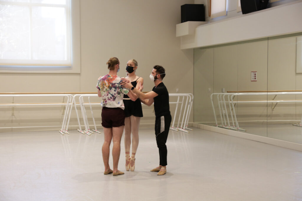 two dancers rehearsing a pas de deux in a studio