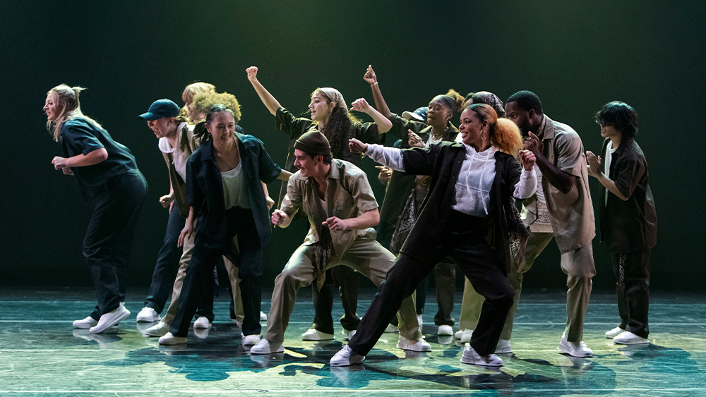 a group of students onstage mid-dance