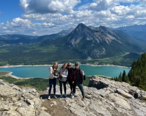 Rhaine Marquardt (BFA '26) posing with family in the Rocky Mountains this past summer